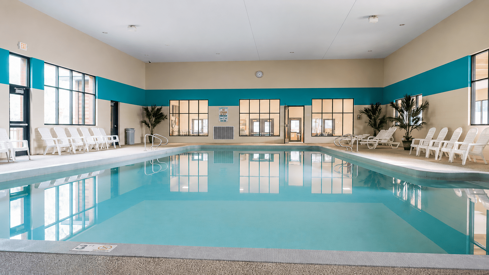 Indoor hotel swimming pool with lounge chairs