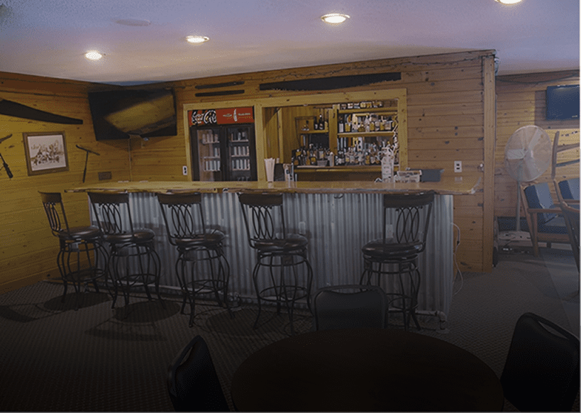 Rustic bar interior with metal stools.