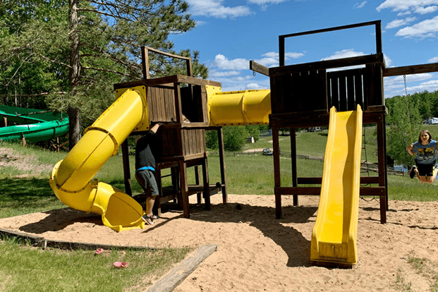 Children's playground with yellow slides outdoors.